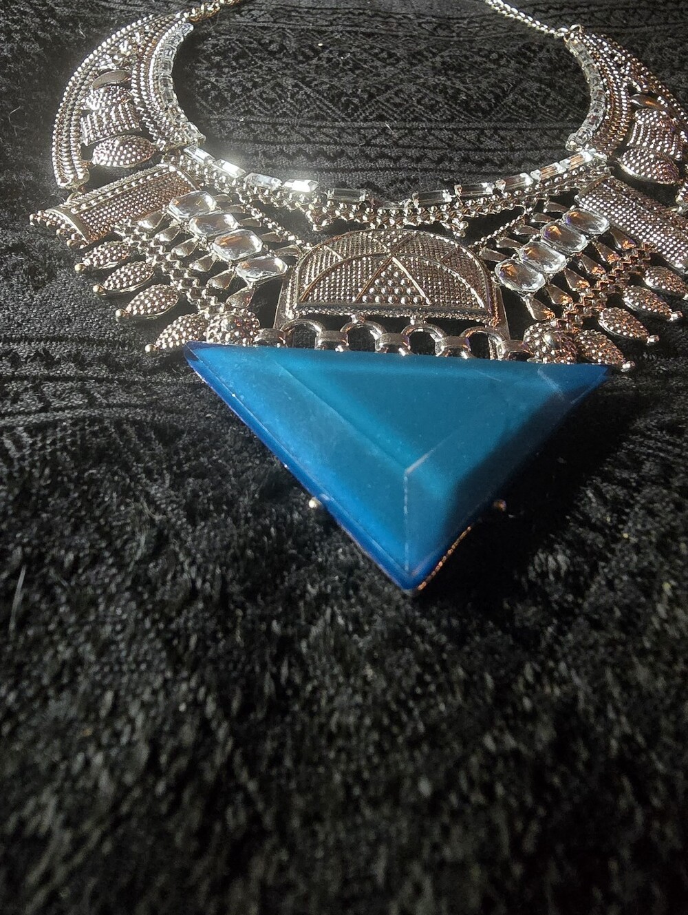 Silver-tone BoHo statement necklace features intricate tribal resin Pendant.